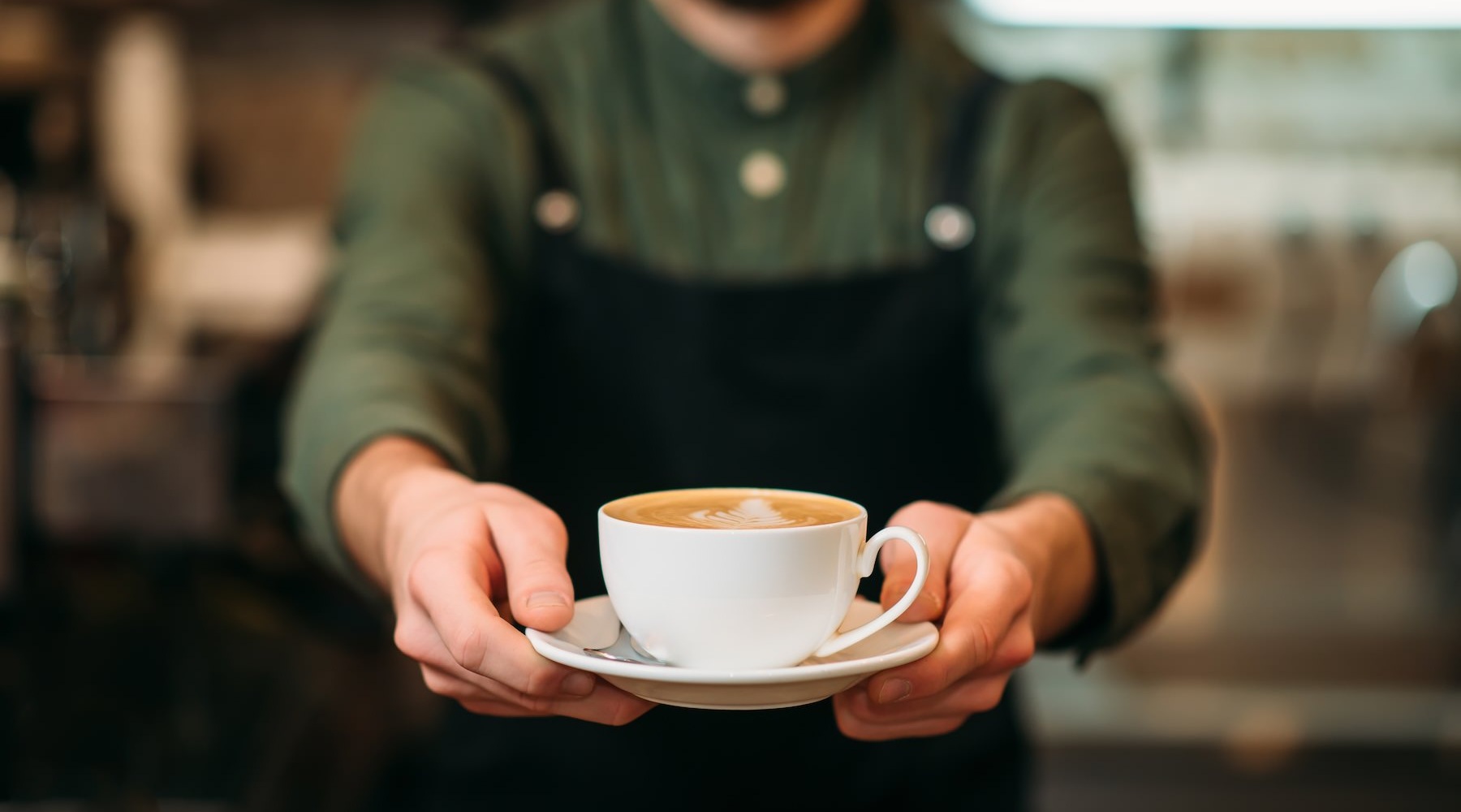 a man holding a cup of coffee